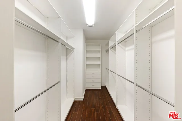 a bathroom with a granite countertop double sink and a mirror