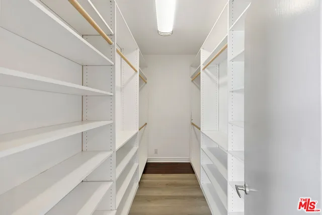 a view of a hallway with wooden floor windows and livingroom