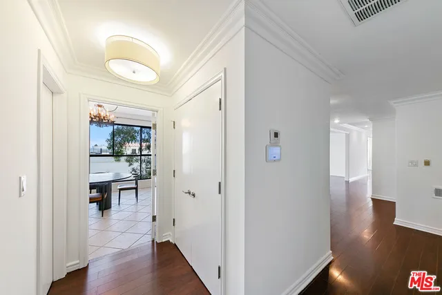 a kitchen with kitchen island granite countertop a stove a sink a refrigerator dining table and chairs