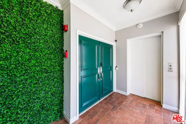 a view of a hallway with wooden floor and entryway