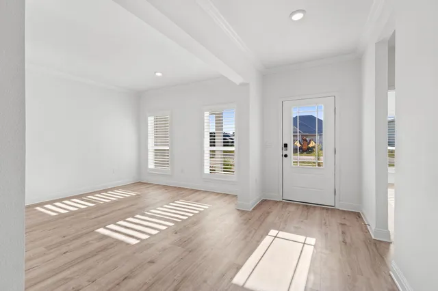 a view of a hallway with wooden floor and staircase