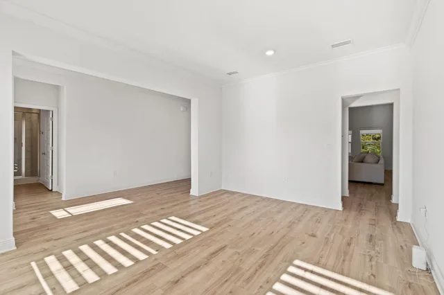 a living room with flat screen tv and a potted plant