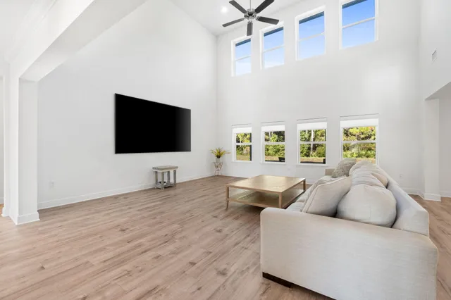 a spacious bathroom with double vanity a mirror and a shower