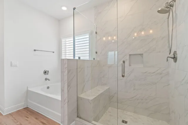 an empty room with windows and wooden floor