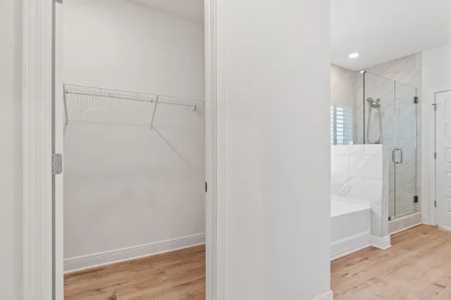 a bathroom with a double vanity sink a toilet a shower and a mirror