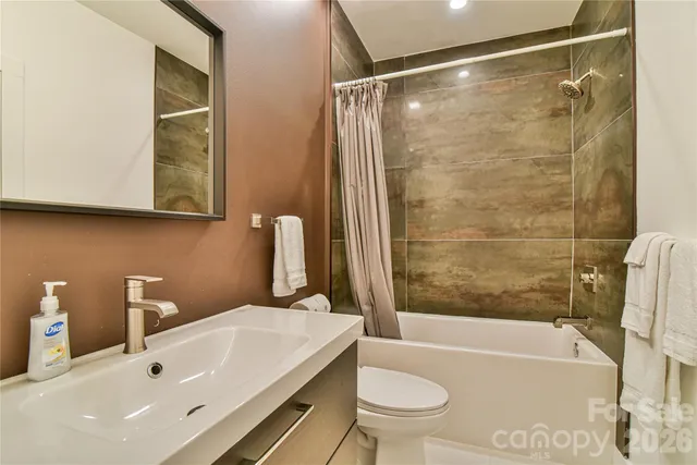 a bedroom with a bed and a lamp