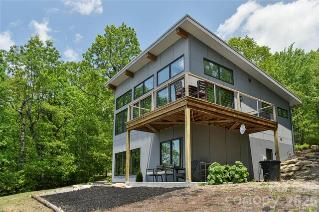 a kitchen with stainless steel appliances granite countertop a stove a sink dishwasher a microwave oven and a dining table with wooden cabinet