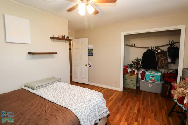a bedroom with a bed and a chandelier