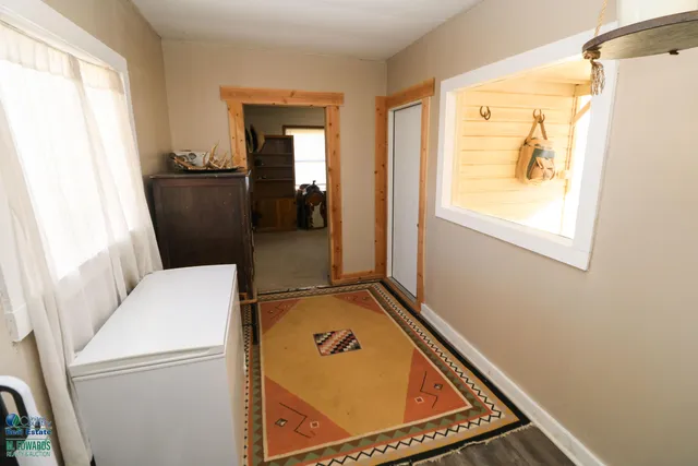 a view of a livingroom with furniture and a window