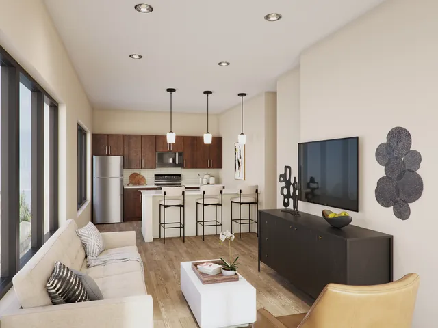 a living room with furniture kitchen view and a window