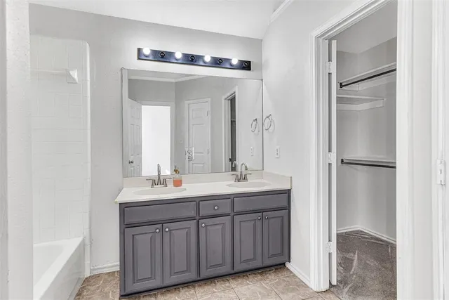 a bathroom with a double vanity sink and mirror