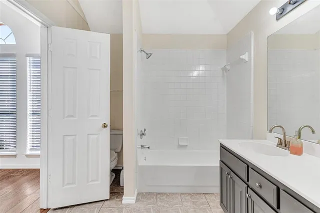 a bathroom with a sink a mirror and a bathtub