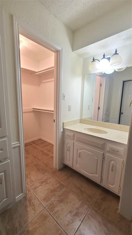 2728 Cross Bend Road Plano, TX 75023 - Photo 11 of 17 a bathroom with a granite countertop sink and a mirror