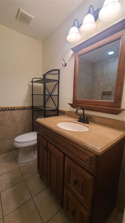 2728 Cross Bend Road Plano, TX 75023 - Photo 14 of 17 a bathroom with a sink a toilet and mirror