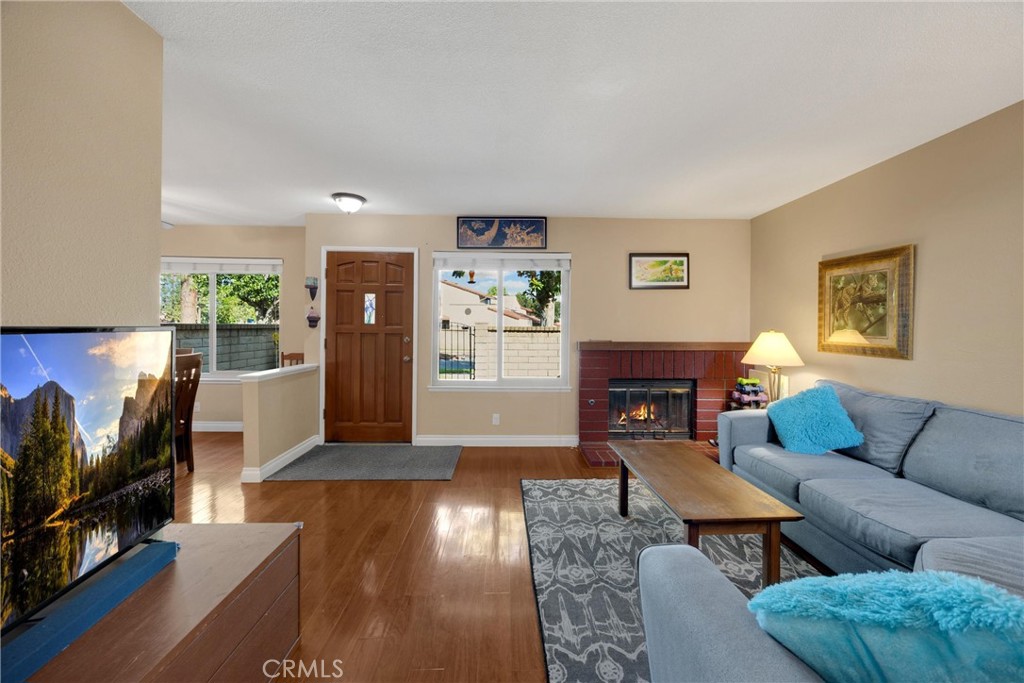 9775 Louise Way Rancho Cucamonga, CA 91730 - Photo 1 of 1 a living room with furniture a flat screen tv and a fireplace