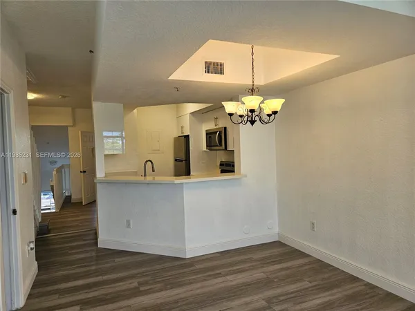 a view of a living room with wooden floor