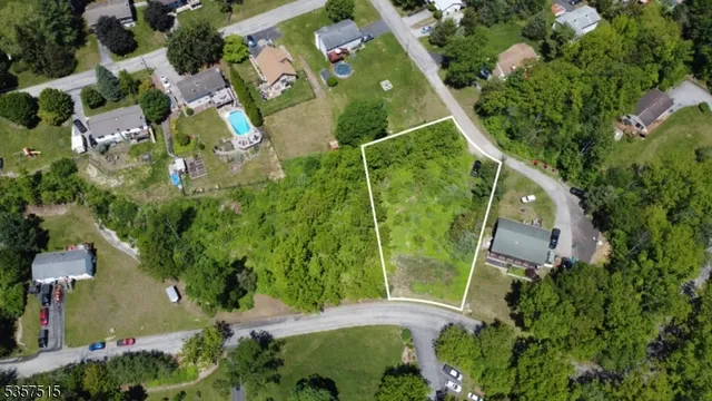 an aerial view of a residential houses with outdoor space and street view