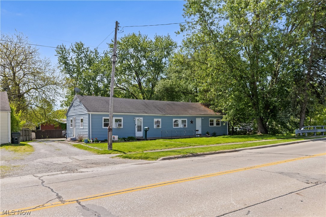 68-70 East Sunset Drive Rittman, OH 44270 - Photo 2 of 49 Light blue siding exterior featuring a dark shingle roof and white trim windows