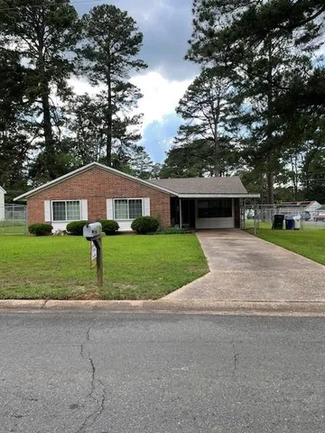 a front view of house with yard and green space