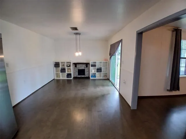 a view of a livingroom with wooden floor and a window