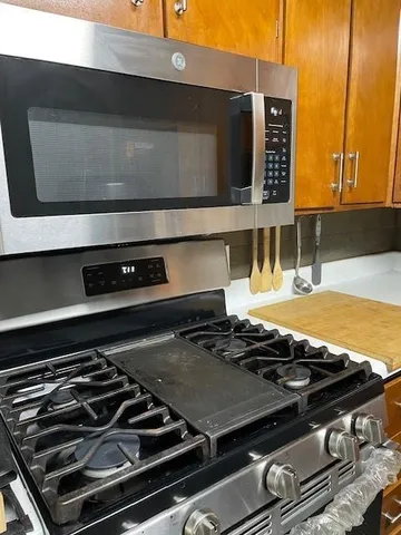 a stove top oven sitting inside of a kitchen