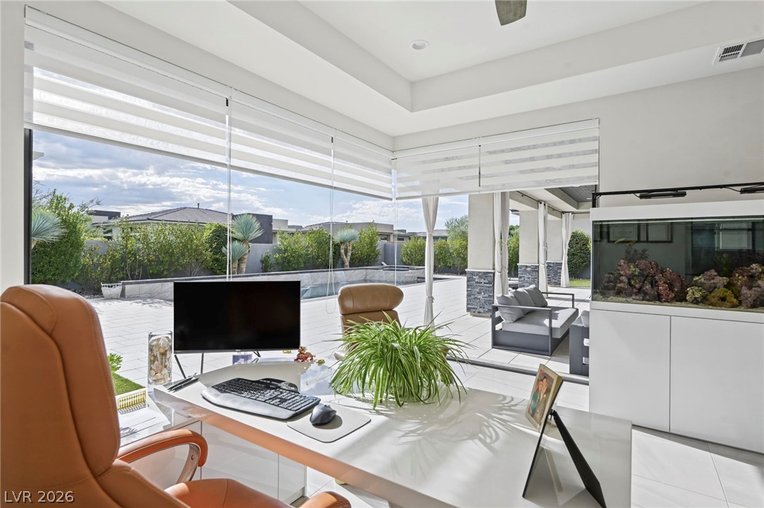 4208 Lapis Ridge Court Las Vegas, NV 89135 - Photo 19 of 61 Massive windows wrap around this home office space overlooking the pool patio.