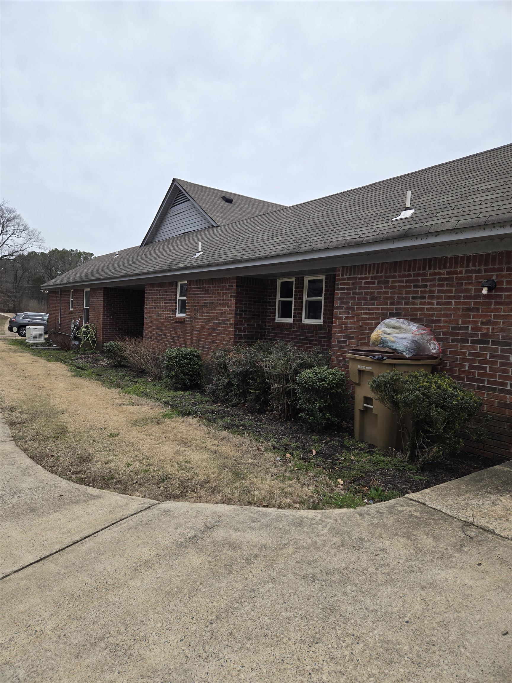 3595 Lucy Road Millington, TN 38053 - Photo 5 of 10 View of side of home featuring brick siding and roof with shingles