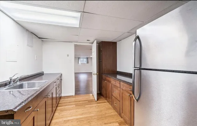 a kitchen with a refrigerator and a sink
