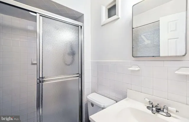 a bathroom with a shower and a sink