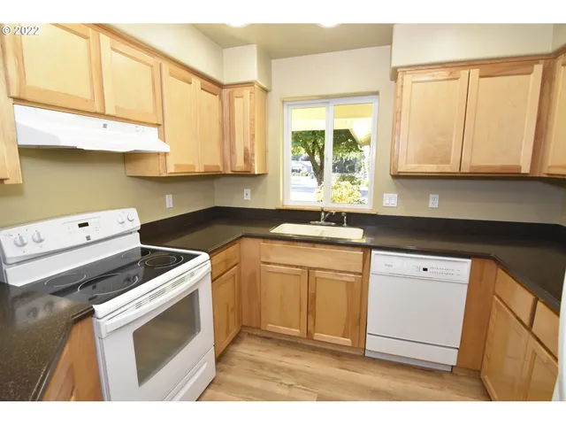 a kitchen with a sink cabinets and window