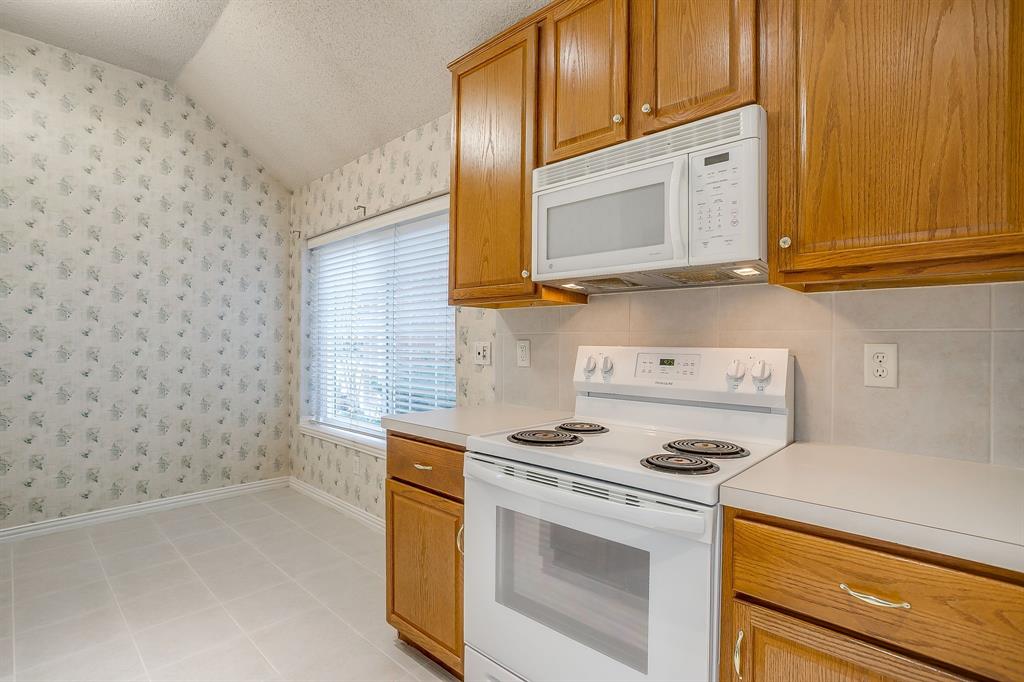 8105 Hosta Way Fort Worth, TX 76123 - Photo 8 of 33 a kitchen with granite countertop cabinets stainless steel appliances and a sink