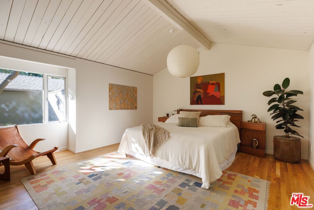 390 North San Rafael Avenue Pasadena, CA 91105 - Photo 15 of 39 a bedroom with a bed and a potted plant