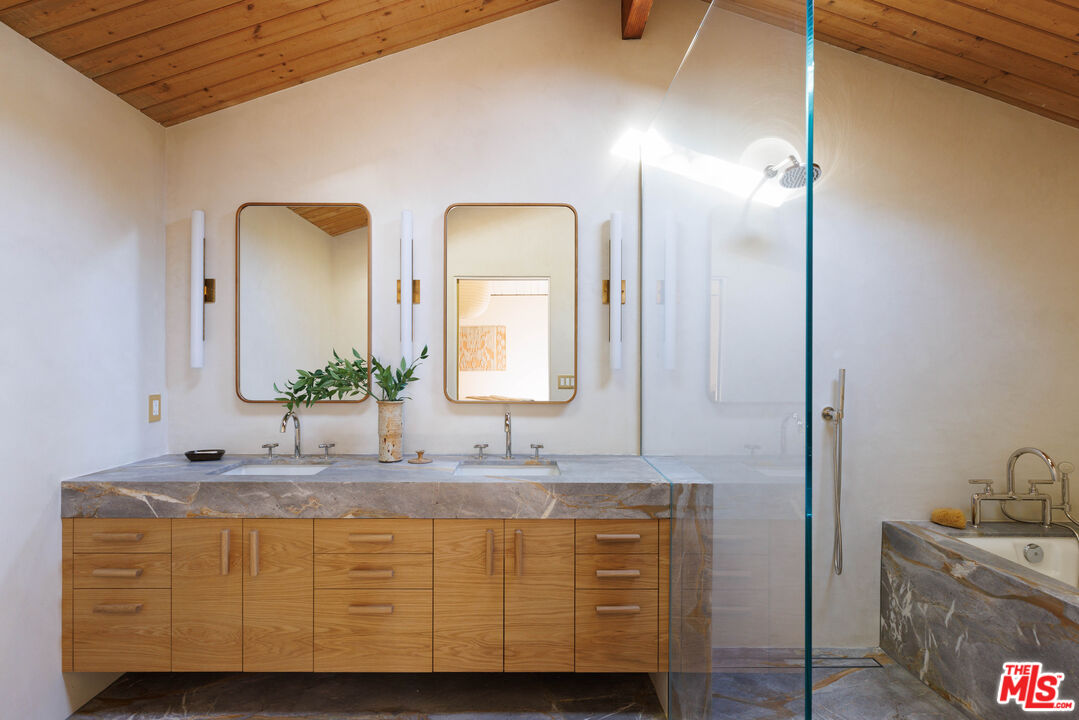 390 North San Rafael Avenue Pasadena, CA 91105 - Photo 17 of 39 a bathroom with a granite countertop sink and a mirror