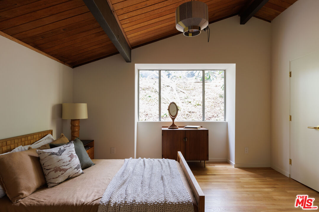 390 North San Rafael Avenue Pasadena, CA 91105 - Photo 22 of 39 a bed room with a bed and wooden floor