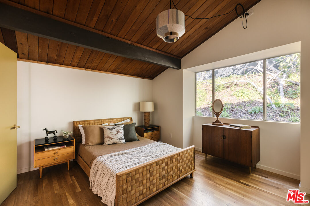 390 North San Rafael Avenue Pasadena, CA 91105 - Photo 23 of 39 a bedroom with a bed and a large window