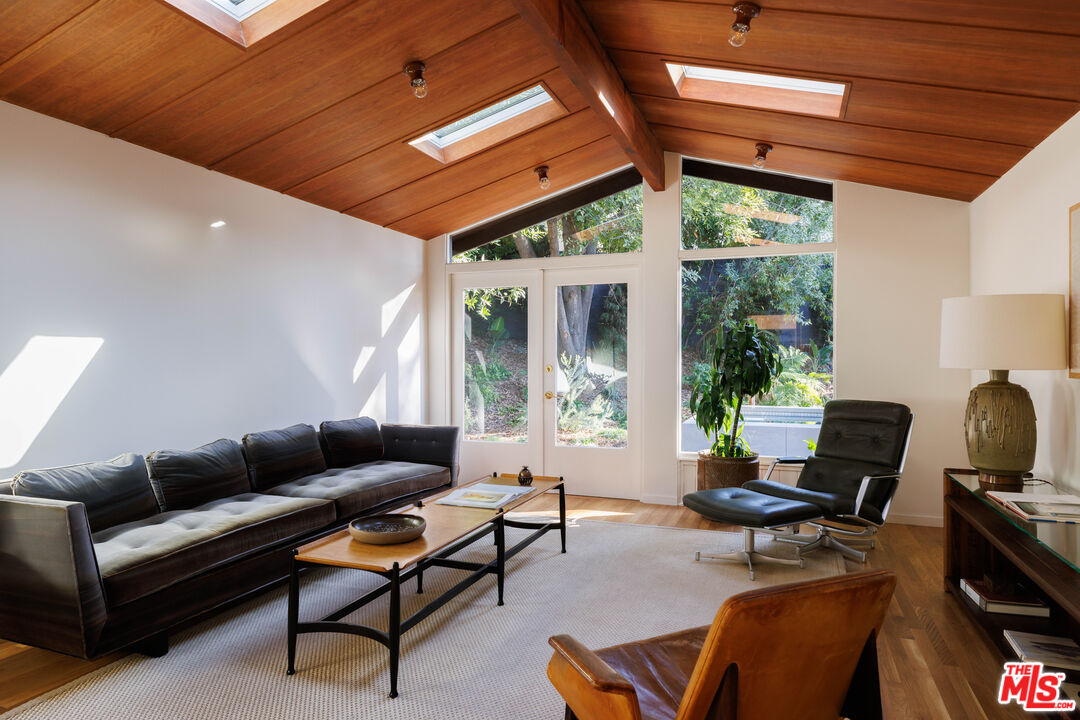 390 North San Rafael Avenue Pasadena, CA 91105 - Photo 29 of 39 a living room with furniture a flat screen tv and a large window