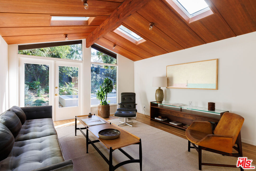 390 North San Rafael Avenue Pasadena, CA 91105 - Photo 31 of 39 a living room with furniture a flat screen tv and a floor to ceiling window