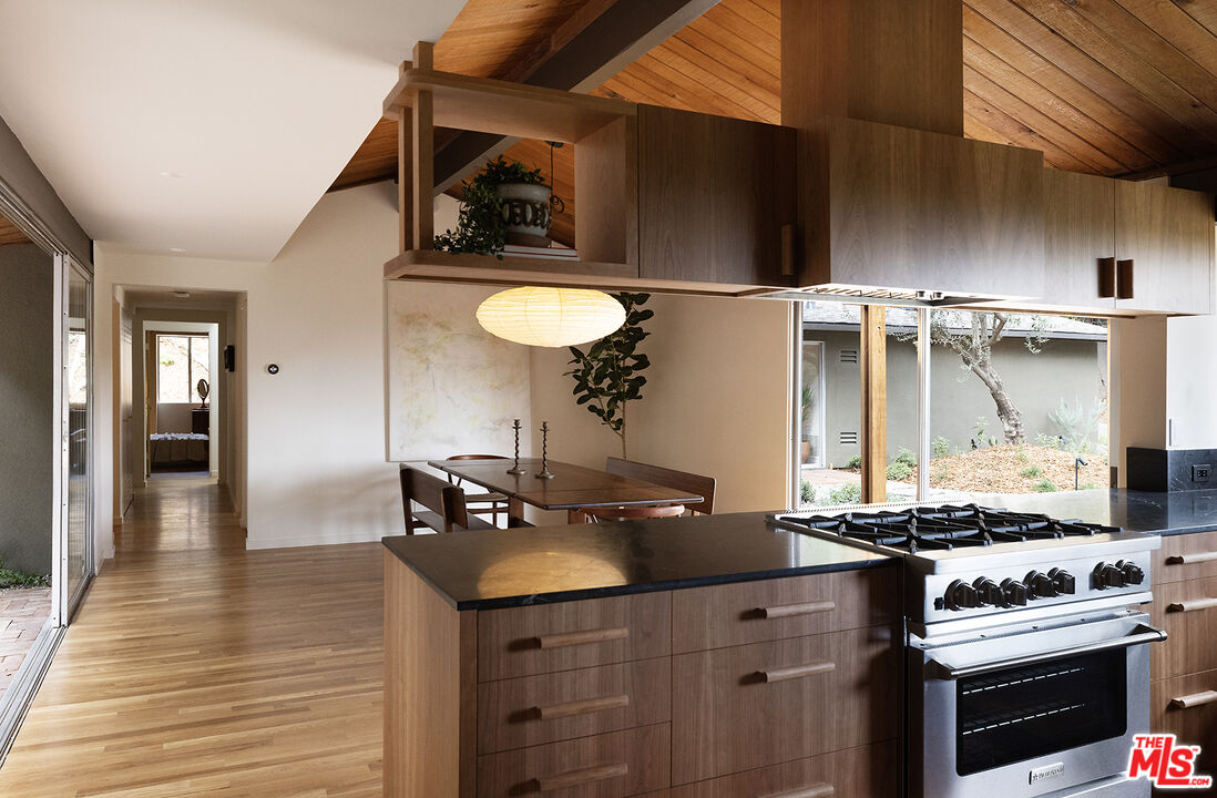 390 North San Rafael Avenue Pasadena, CA 91105 - Photo 5 of 39 a kitchen with a sink dishwasher a stove and a refrigerator with wooden floor