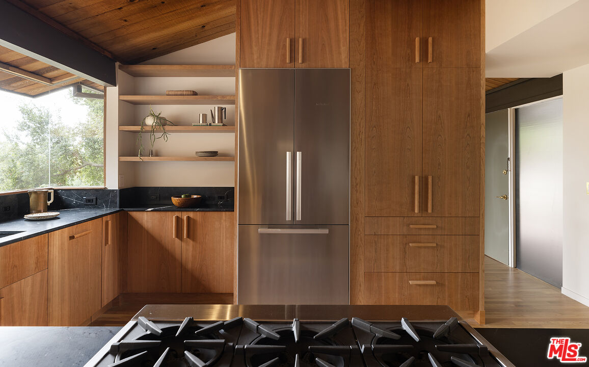 390 North San Rafael Avenue Pasadena, CA 91105 - Photo 10 of 39 a kitchen with stainless steel appliances a refrigerator and a sink