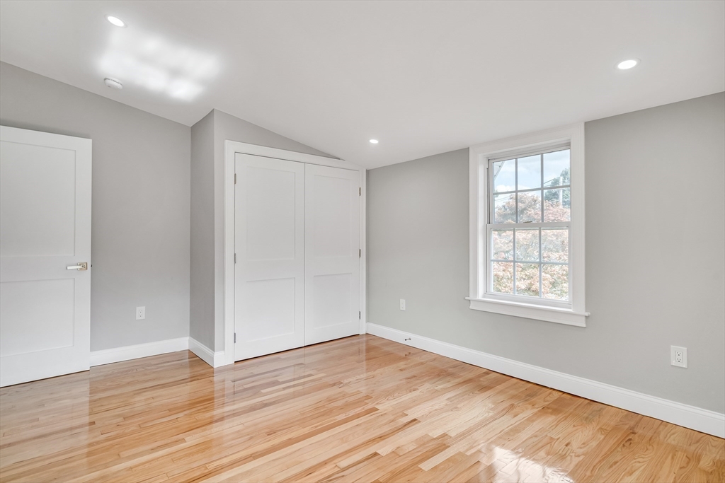 39 Abbott Road Waltham, MA 02452 - Photo 13 of 18 a view of an empty room with wooden floor and a window