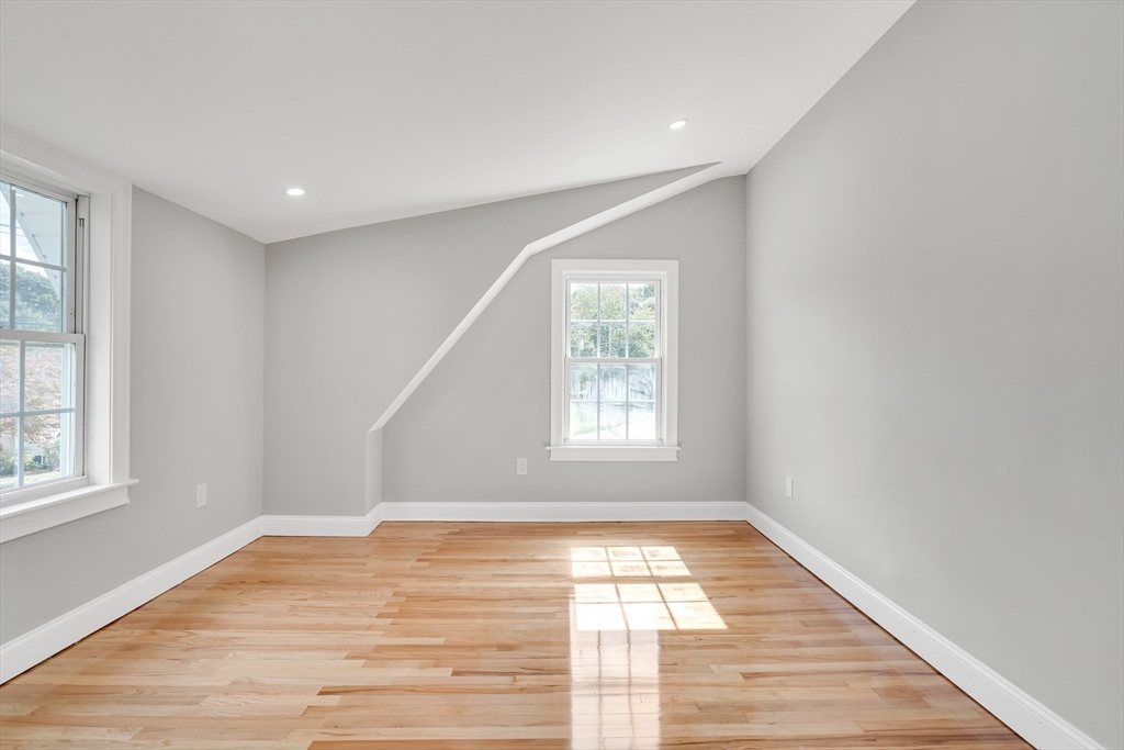 39 Abbott Road Waltham, MA 02452 - Photo 14 of 18 an empty room with wooden floor and windows