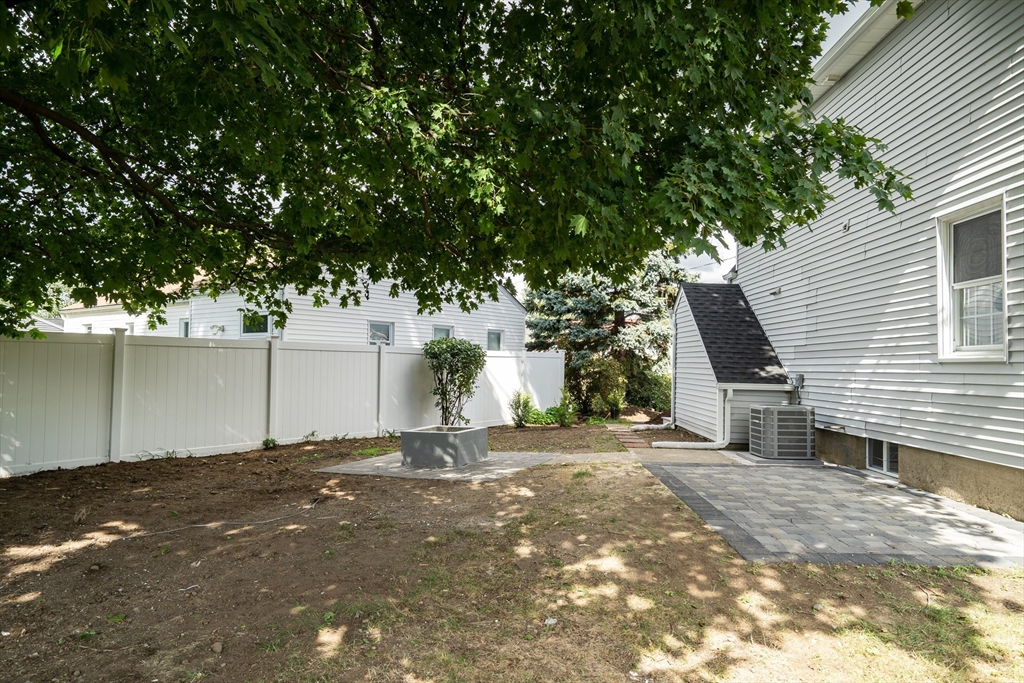 39 Abbott Road Waltham, MA 02452 - Photo 18 of 18 a backyard of a house with lots of green space