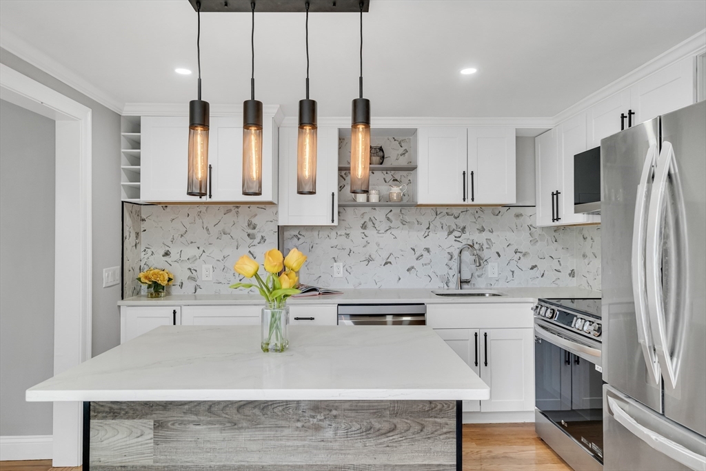 39 Abbott Road Waltham, MA 02452 - Photo 5 of 18 a kitchen with stainless steel appliances granite countertop a sink a stove and a refrigerator