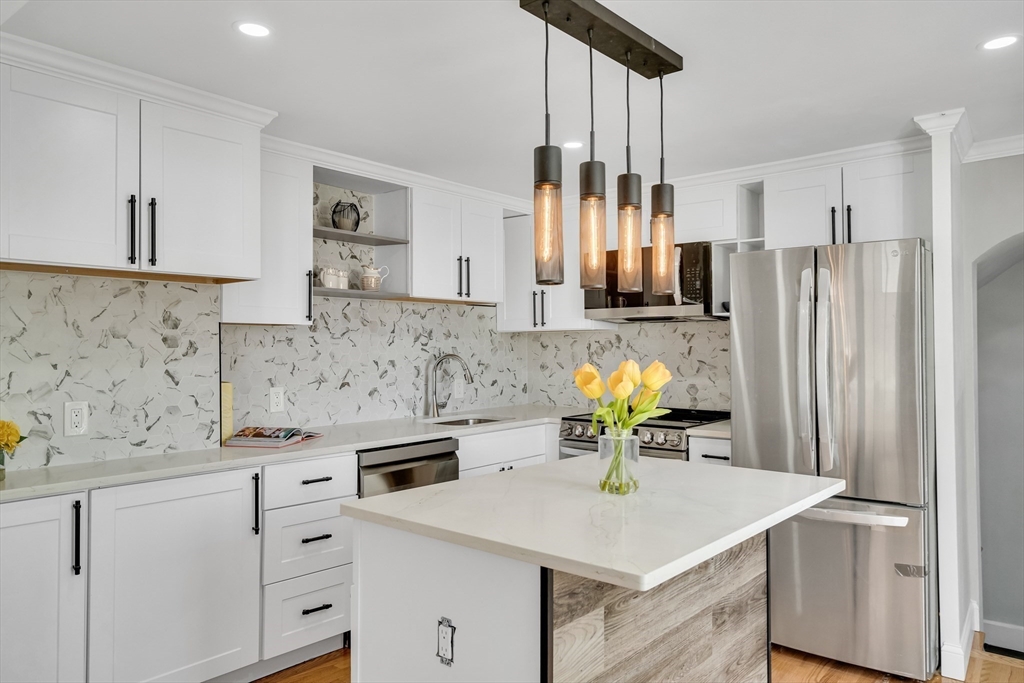 39 Abbott Road Waltham, MA 02452 - Photo 6 of 18 a kitchen with stainless steel appliances a stove a sink and a refrigerator