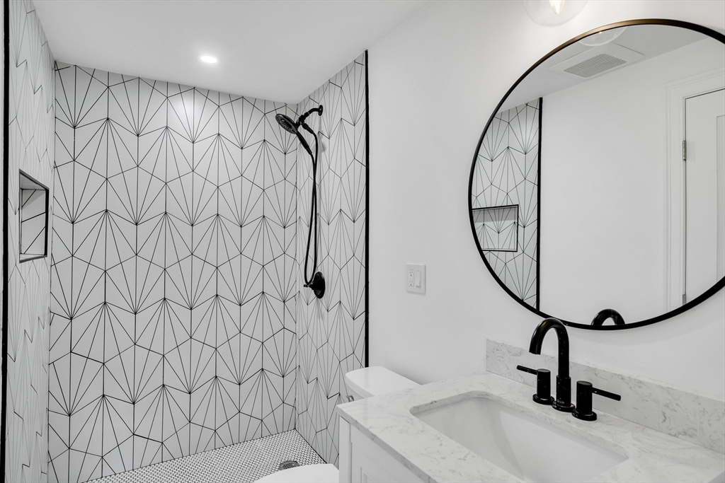 39 Abbott Road Waltham, MA 02452 - Photo 9 of 18 a bathroom with a shower curtain and mirror