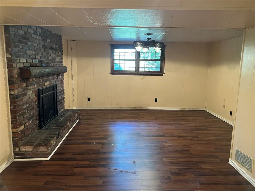 470 Donohoe Road Greensburg, PA 15601 - Photo 12 of 31 an empty room with wooden floor fireplace and windows