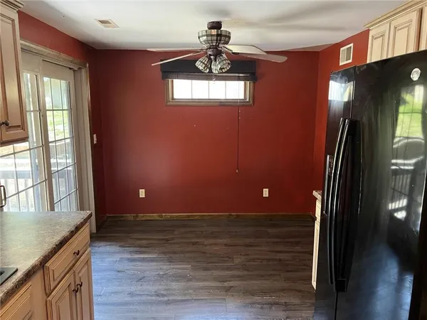 a view of a livingroom with a ceiling fan and window