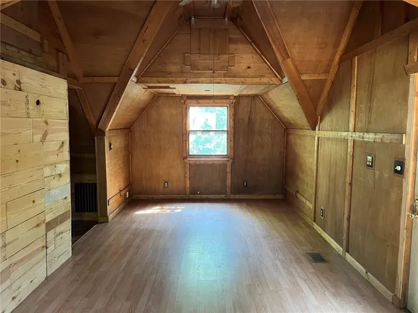 a view of hallway with wooden floor and stairs