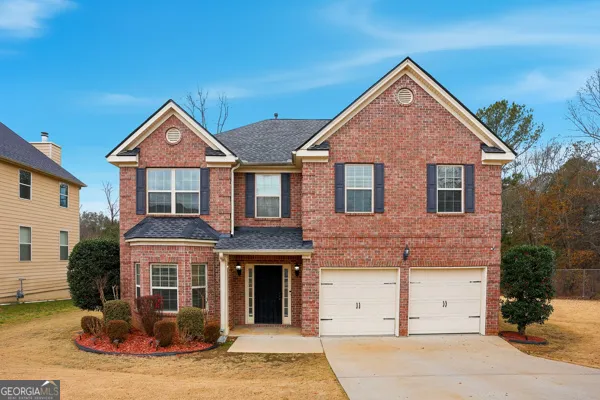 a front view of a house with yard