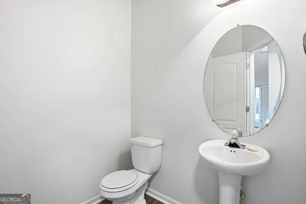 a bathroom with a sink a mirror and a toilet
